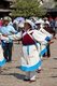 China: Naxi women dance in Old Market Square (Sifang Jie), Lijiang Old Town, Yunnan Province