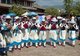 China: Naxi women dance in Old Market Square (Sifang Jie), Lijiang Old Town, Yunnan Province